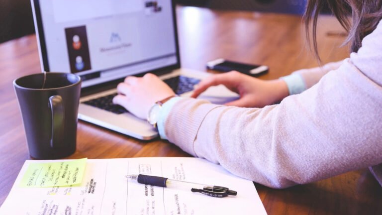 Business professionals discussing digital marketing strategies on a laptop to increase online visibility, brand awareness, and business growth.